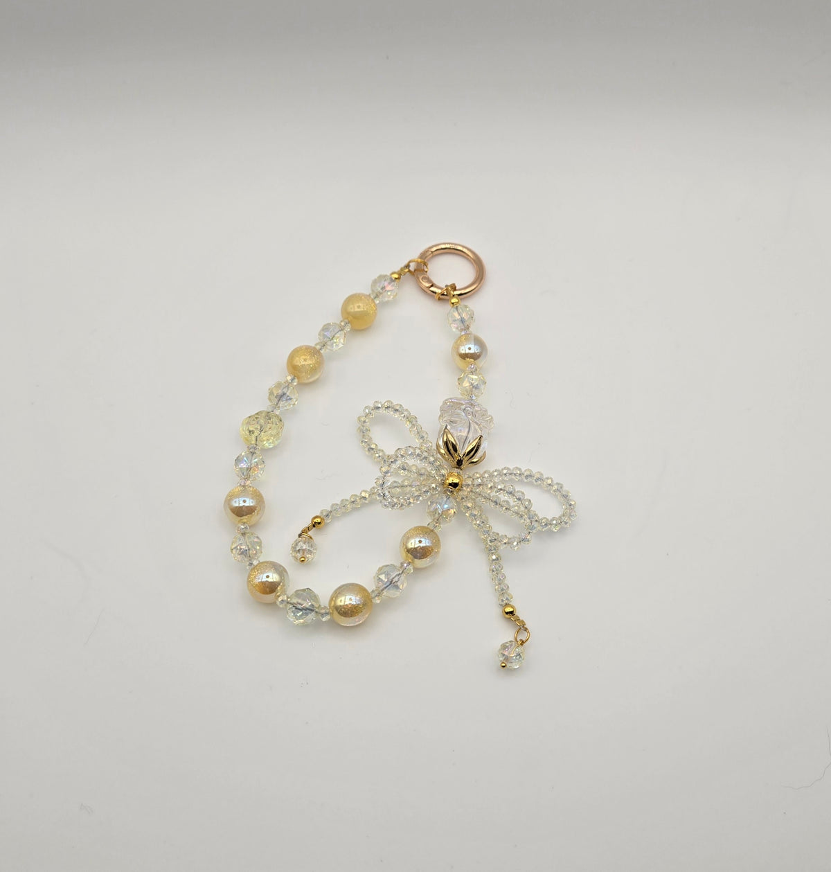Yellow Crystal Bow phone charm with golden beads and sparkling beaded bow