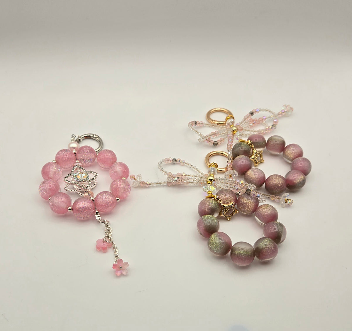 Starlit Blush phone charm designs in blush pink with floral, bow and celestial accents
