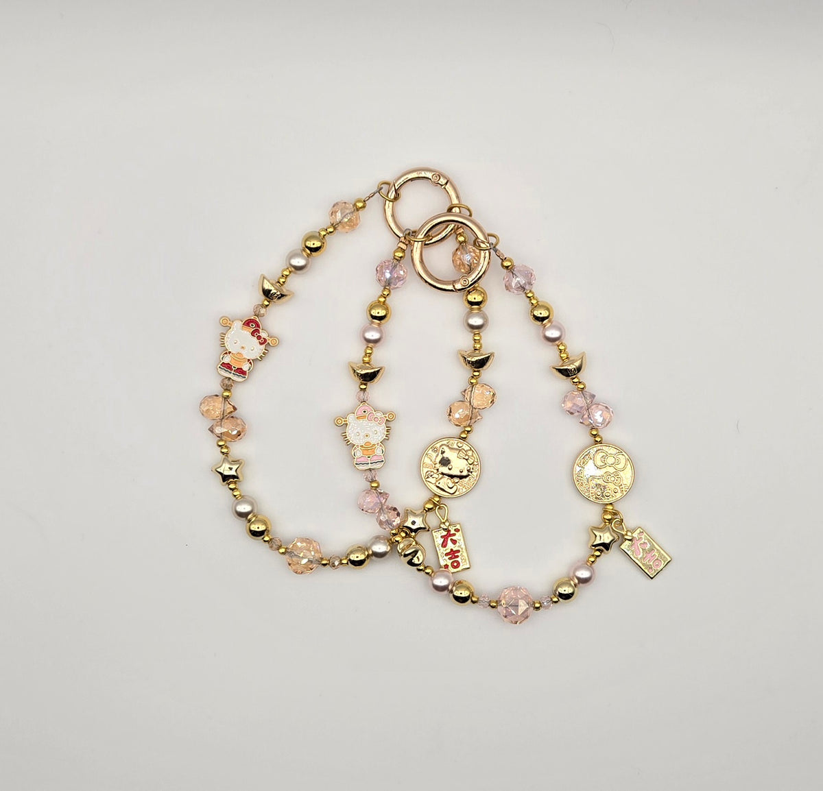 Lucky Kitty phone charms with pink crystal beads, gold accents and character-inspired details
