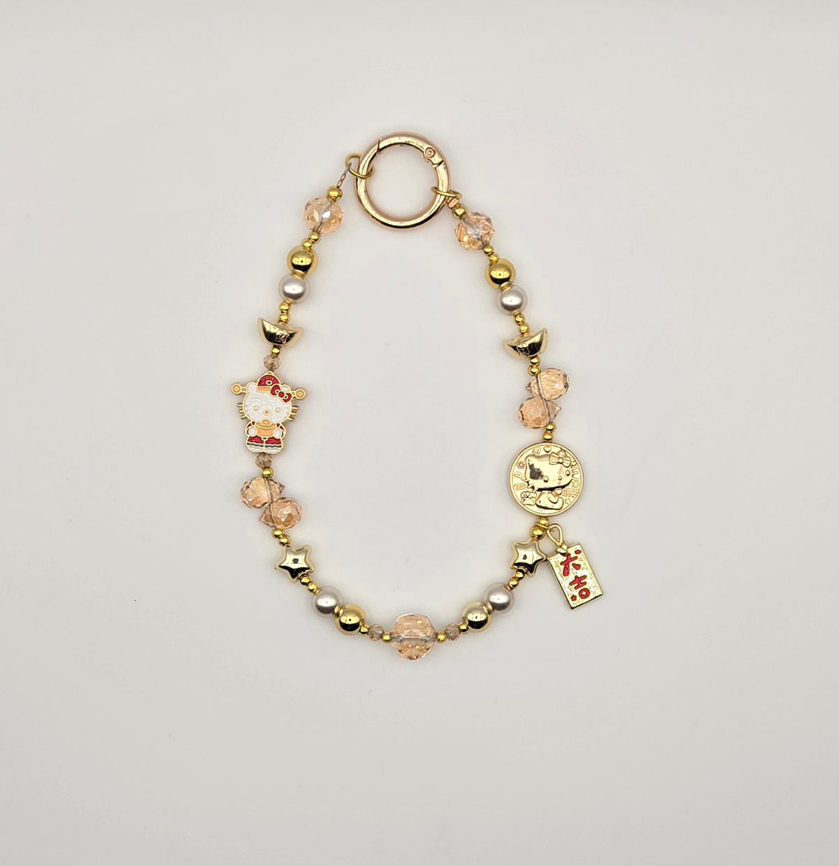 Lucky Kitty phone charm with red accents, pink crystal beads and gold character-inspired details