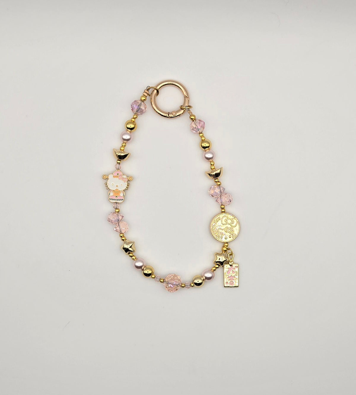 Lucky Kitty phone charm with pink accents, pink crystal beads and gold character-inspired details