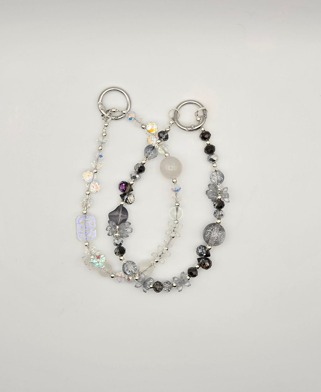 Twilight Frost beaded phone charms in black smoky gray and clear iridescent styles with silver-tone details