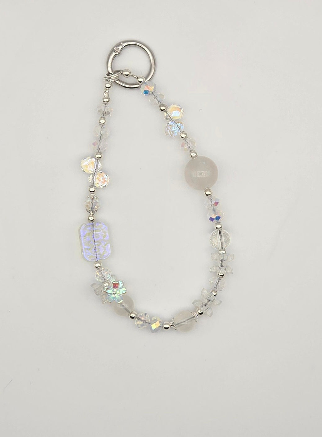 Crystal Frost clear and iridescent beaded phone charm with floral accents and silver-tone details