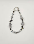 Midnight Frost black and smoky gray beaded phone charm with floral accents and silver-tone details