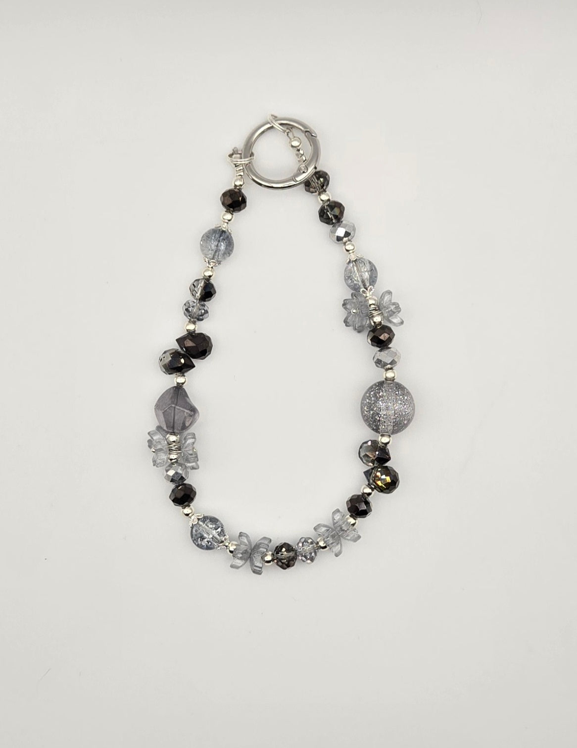 Midnight Frost black and smoky gray beaded phone charm with floral accents and silver-tone details