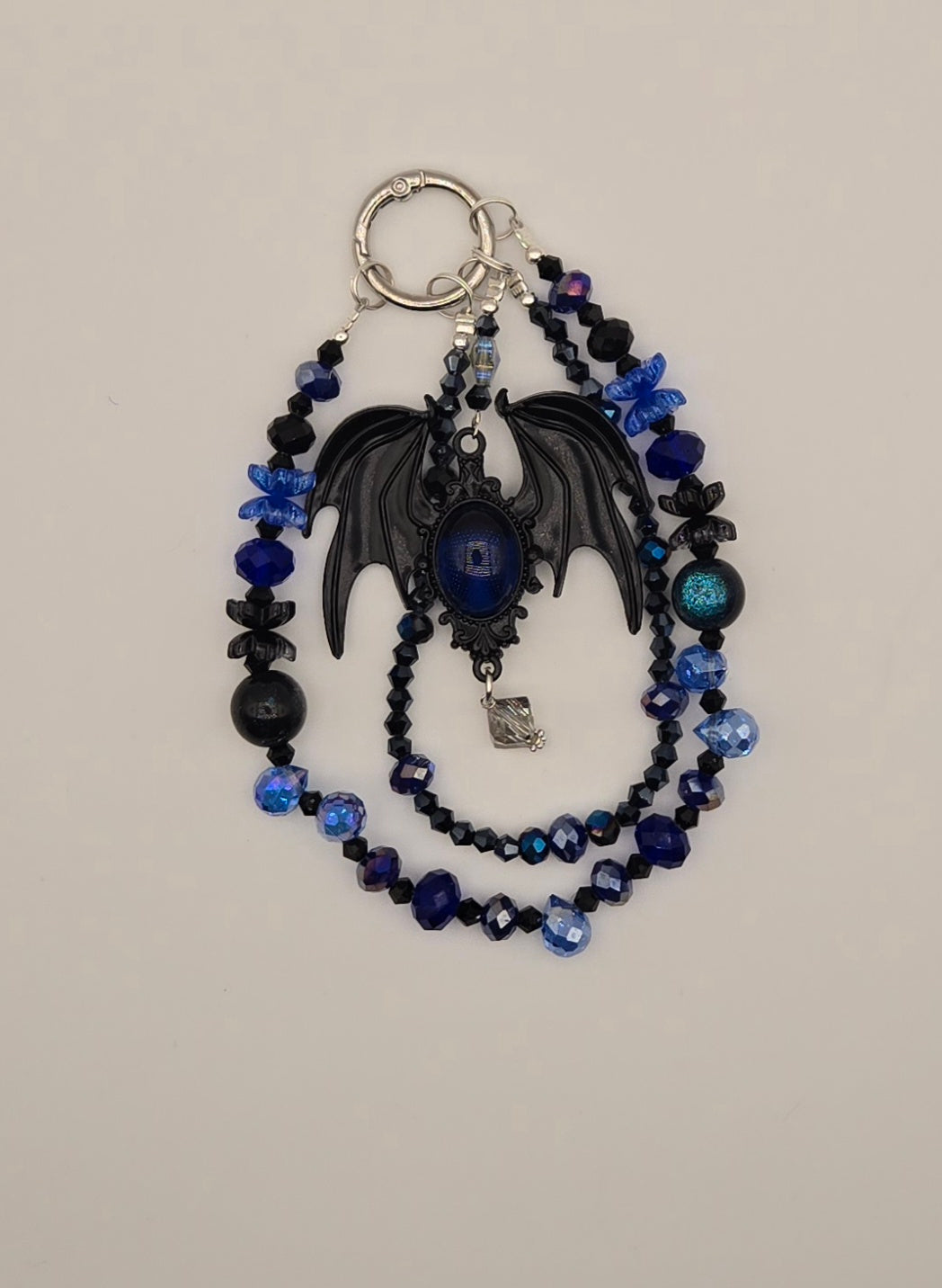 Midnight blue bat phone charm with black wings, blue faceted beads and silver-tone hardware