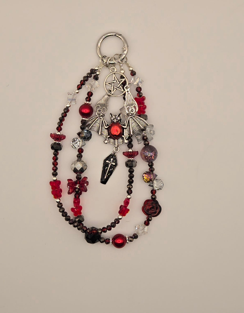 Crimson red and black bat phone charm with silver-tone bat, pentacle and layered beaded strands