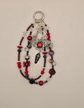 Crimson red and black bat phone charm with silver-tone bat, pentacle and layered beaded strands