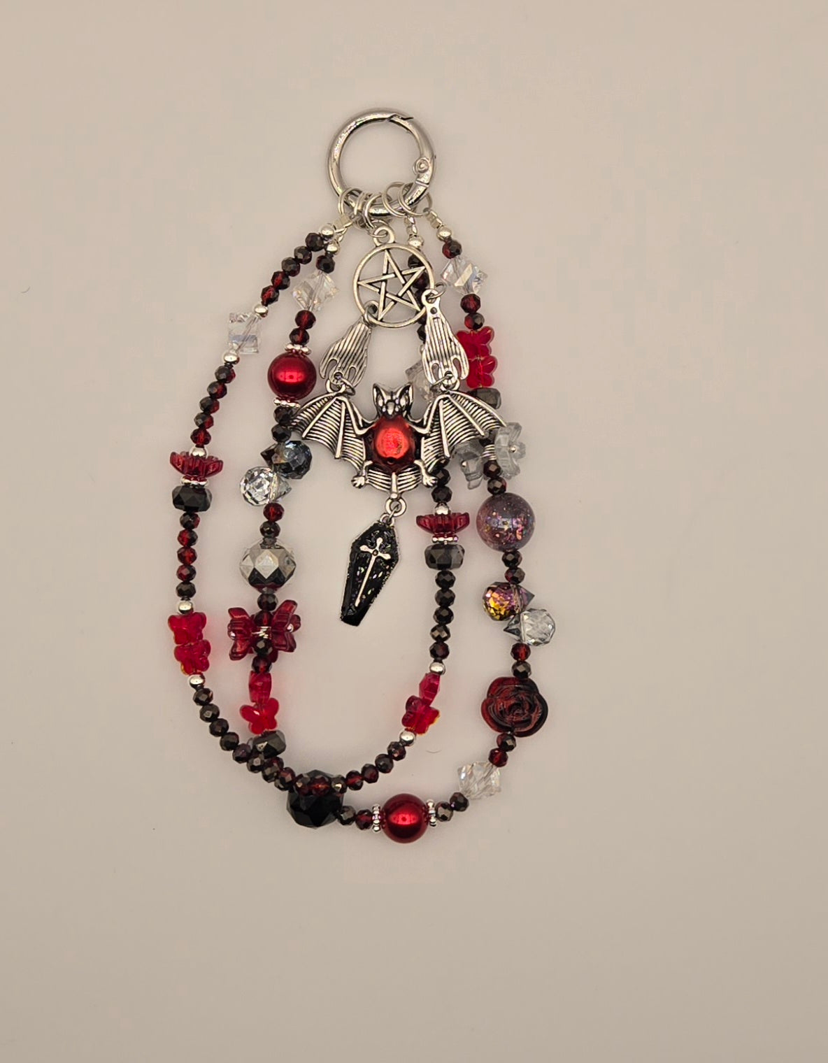Crimson red and black bat phone charm with silver-tone bat, pentacle and layered beaded strands