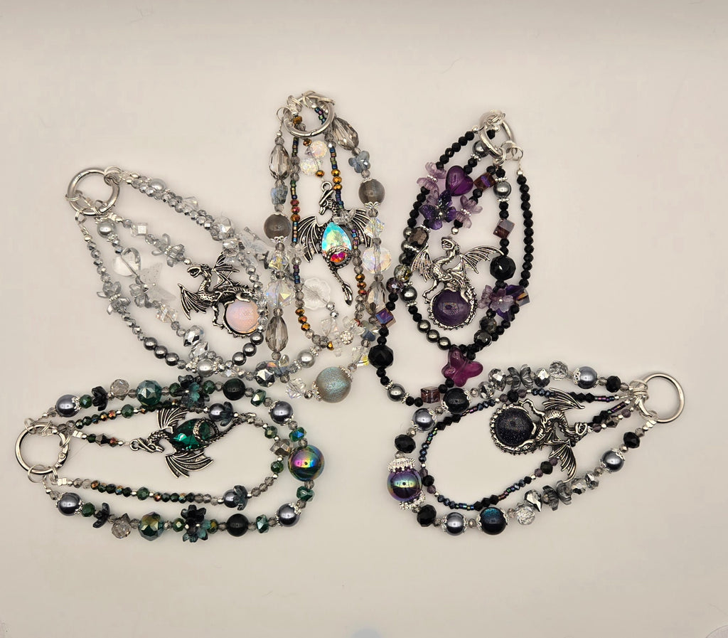 Assorted Dragon Magic multi-strand beaded phone charms with silver-tone dragon designs