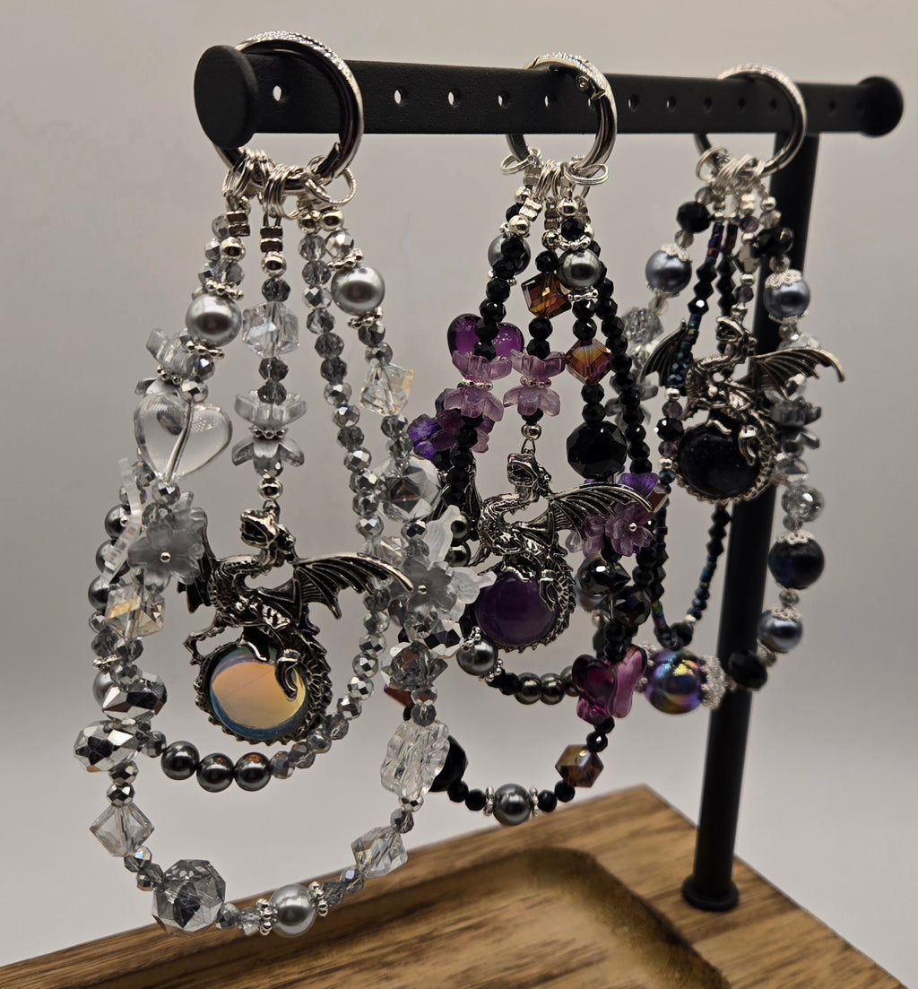 Dragon Magic beaded phone charms with silver-tone dragon focal charms displayed on a black stand