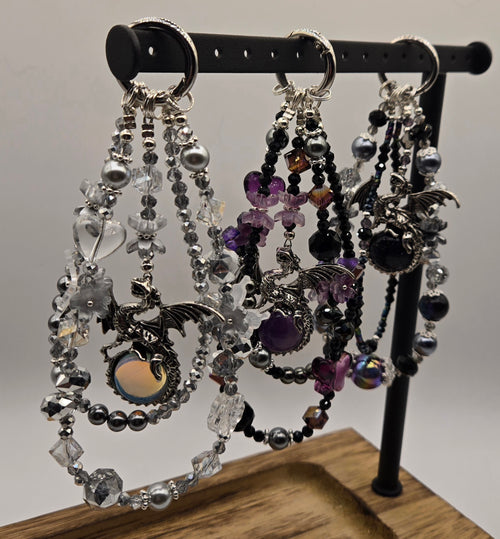 Dragon Magic beaded phone charms with silver-tone dragon focal charms displayed on a black stand