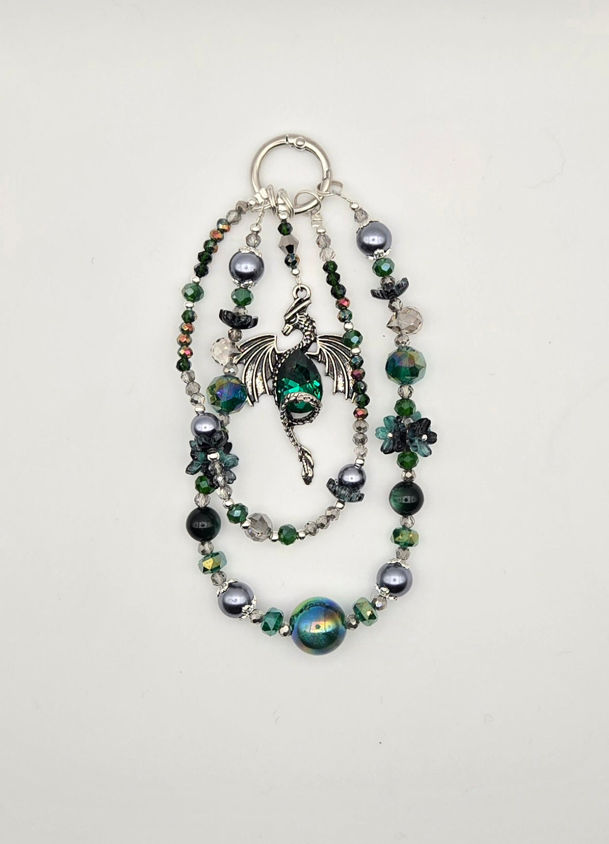 Emerald Keeper Dragon phone charm with green, black and silver beaded strands