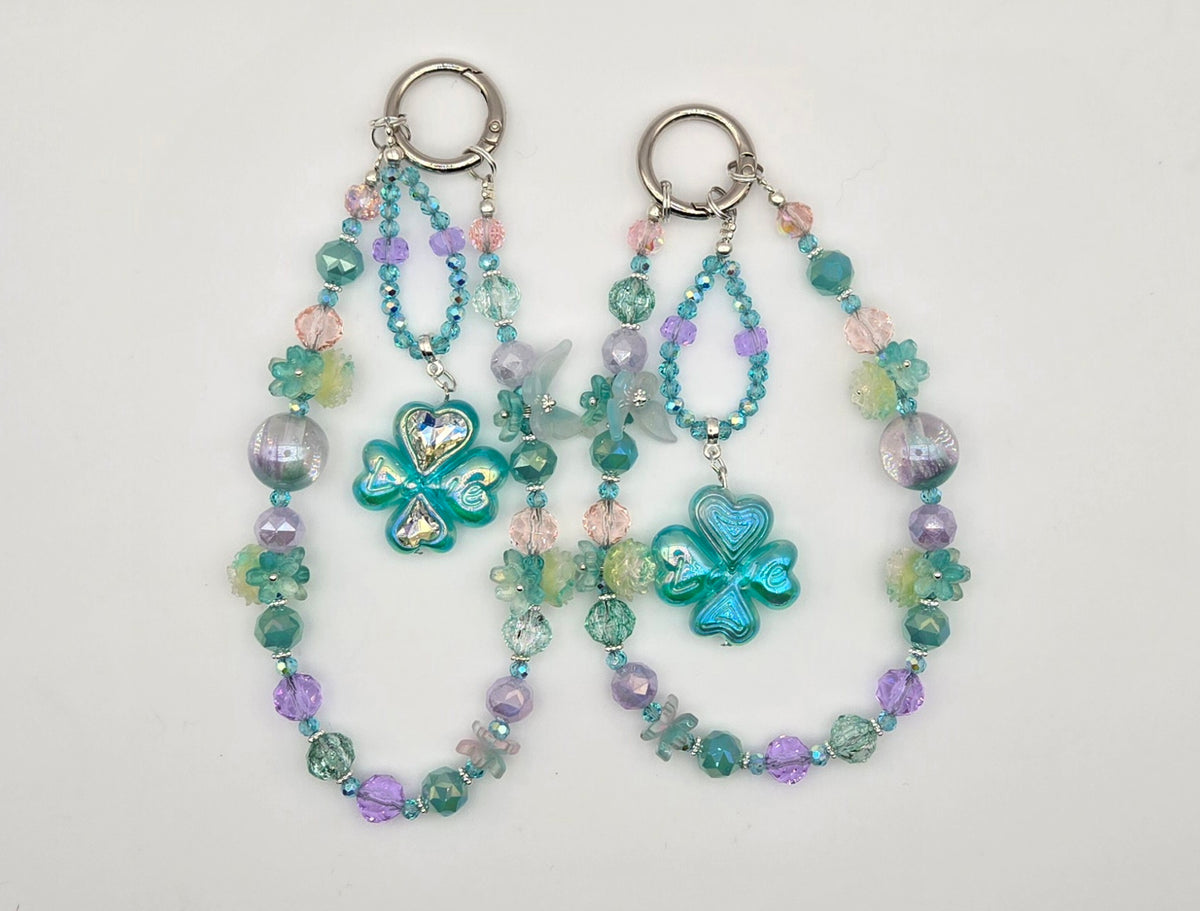 Whimsical Meadow Enchanted Clover phone charms with aqua, lavender and pastel beads and floral accents