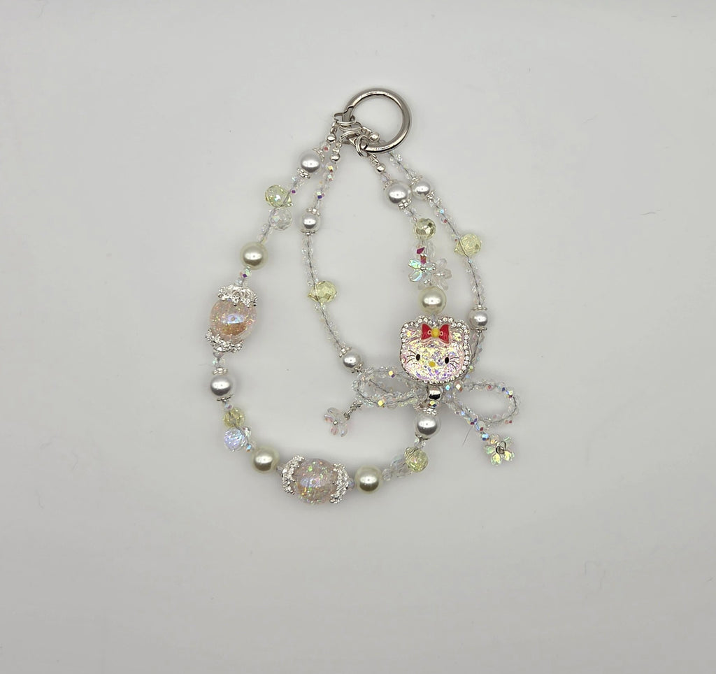 Sparkling cat phone charm with pastel beads, pearls, and dangling cat accent
