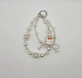 Sparkling cat phone charm with pastel beads, pearls, and dangling cat accent