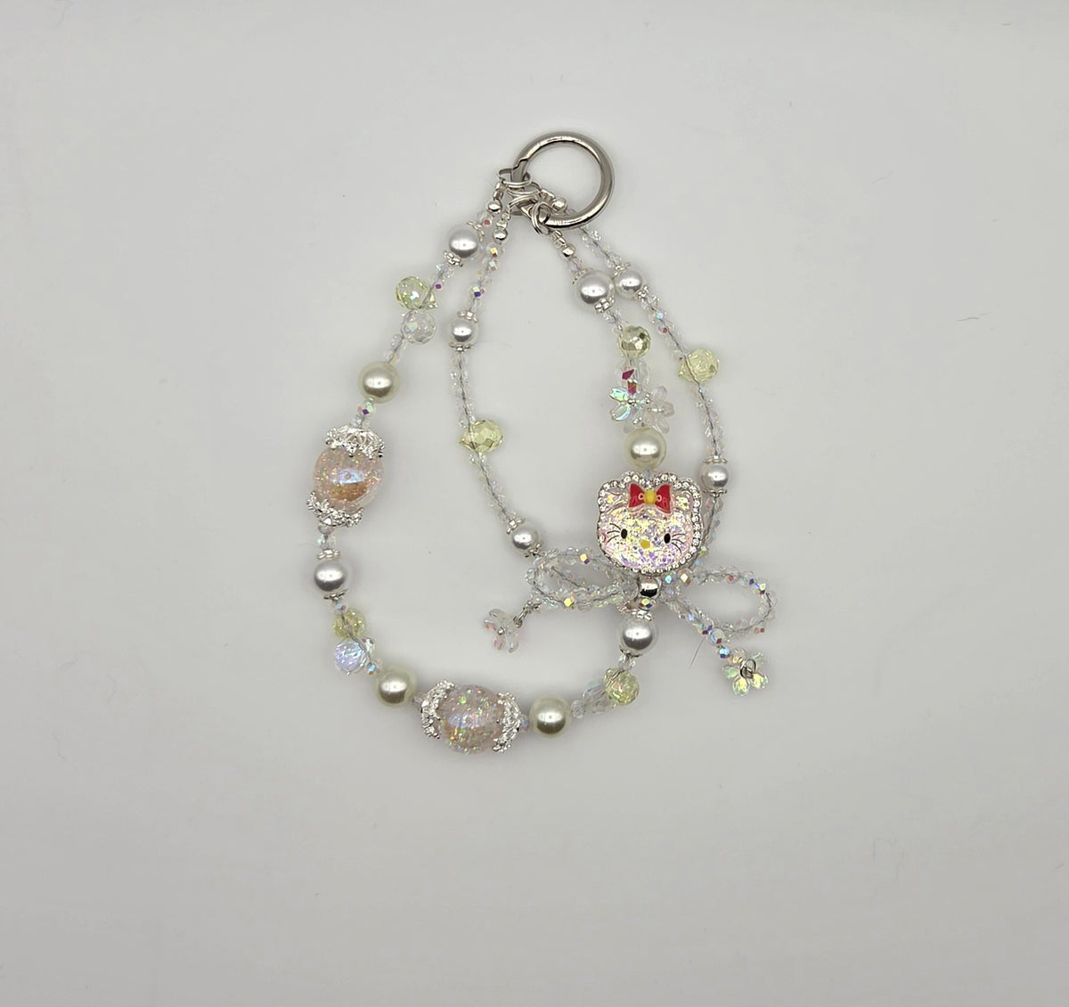 Sparkling cat phone charm with pastel beads, pearls, and dangling cat accent