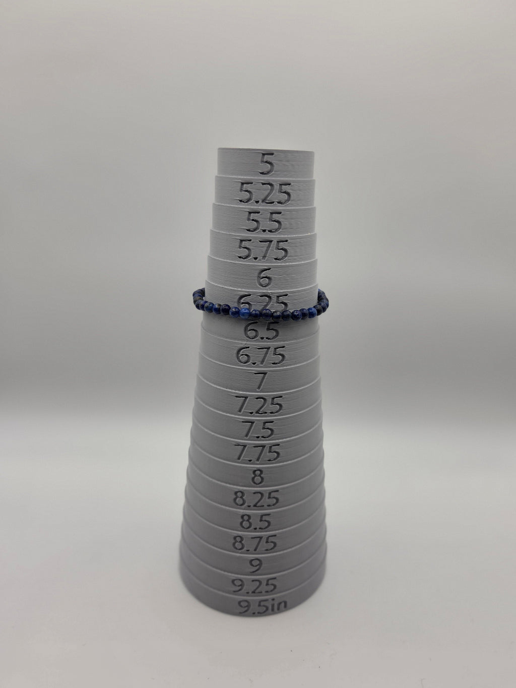 Lapis lazuli bracelet displayed on sizing mandrel at approximately 6.25 inches