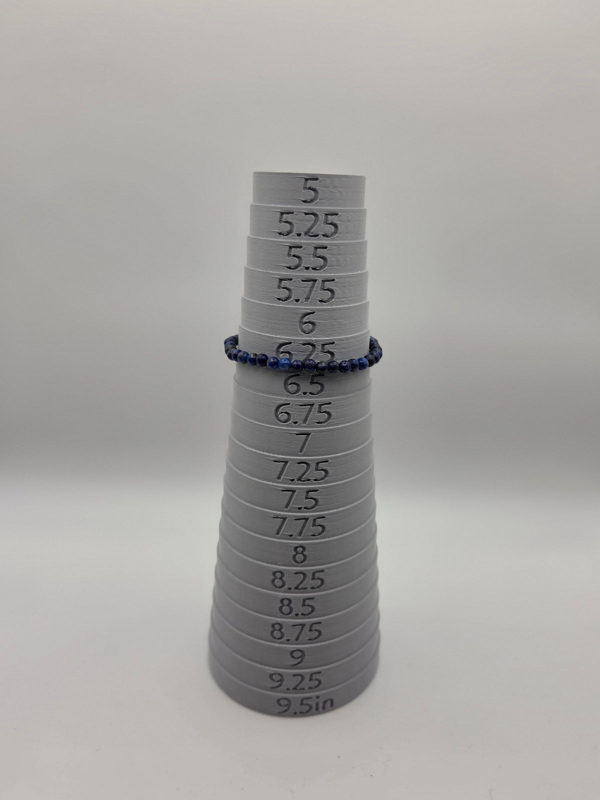 Lapis lazuli bracelet displayed on sizing mandrel at approximately 6.25 inches