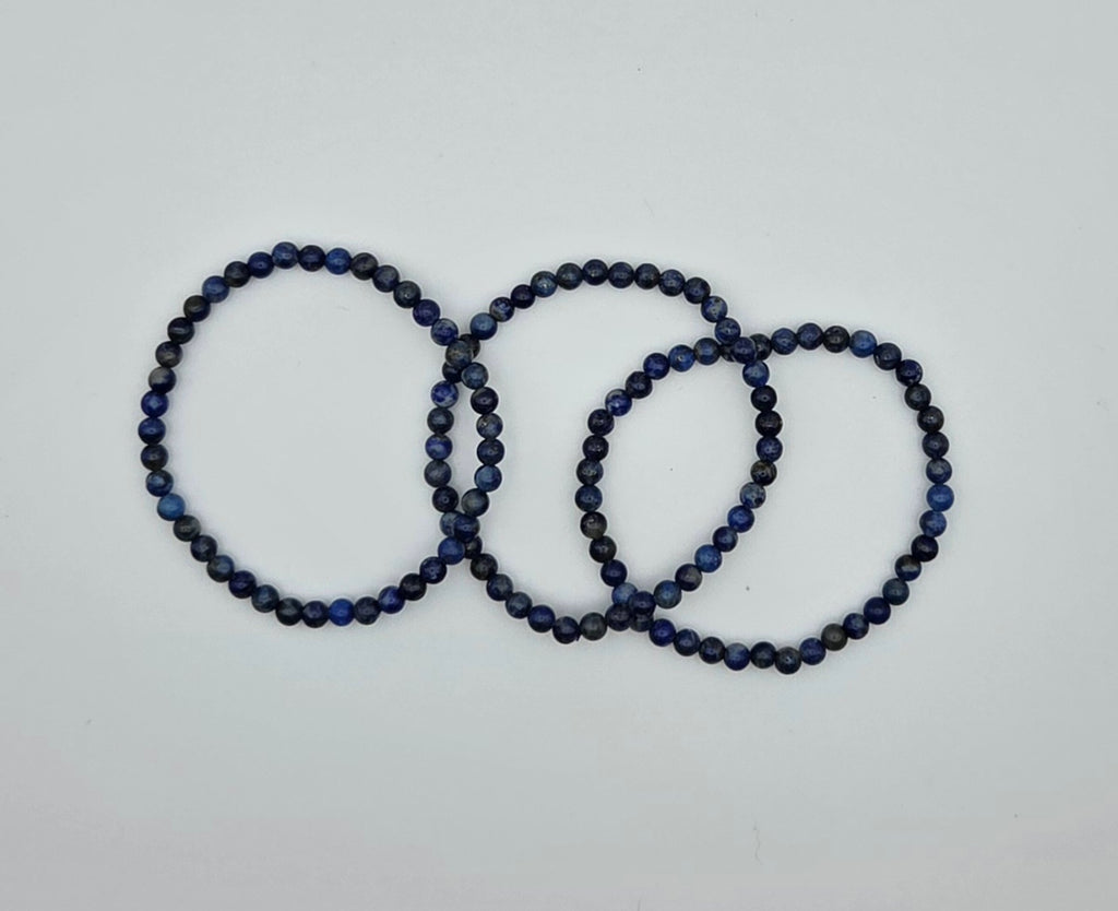 Three lapis lazuli beaded bracelets showing natural variations in the blue stone beads