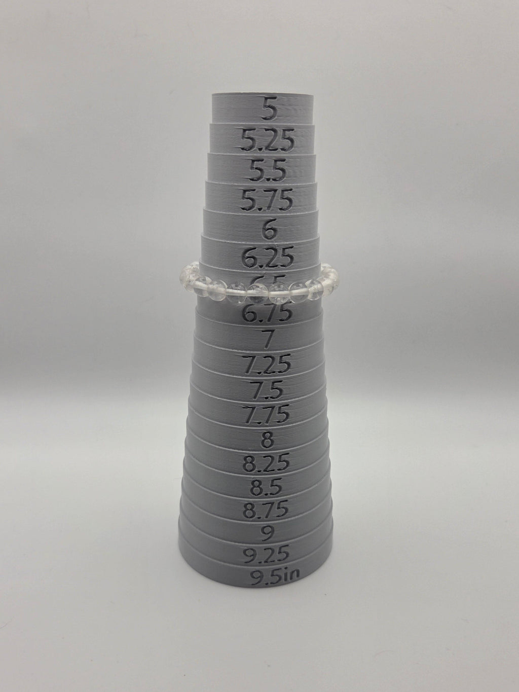 8mm mandrel: 8mm clear quartz beaded bracelet measuring 6.5 inches on a sizing mandrel